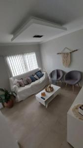 a living room with a couch and a table at La beethoven YB in Yerba Buena