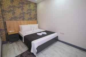Postel nebo postele na pokoji v ubytování Minimalist Suit Otel