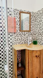 a bathroom with a sink and a mirror at Apart Pousada Villa das Flores in Penha +55 photos