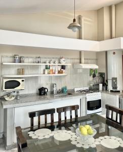a kitchen with a glass table with chairs and a stove at CardON Apart in San Fernando del Valle de Catamarca +4 photos