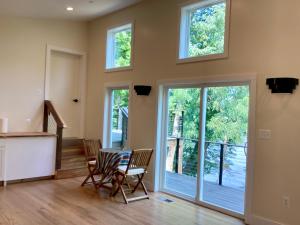 a living room with a table and chairs and windows at Riva Loft with a View in Riva