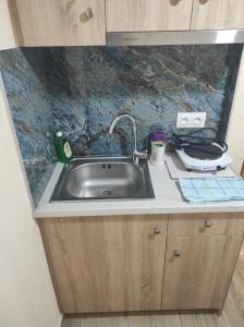 a sink in a kitchen with a counter top at Light Blue Paralia Apartments in Paralia Katerinis