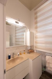 a bathroom with a sink and a mirror at Suite Piazza del Popolo in Ascoli Piceno