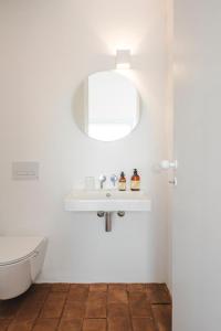 a white bathroom with a sink and a toilet at Vagar do Pastor in Alandroal +78 photos
