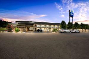 a hotel with two cars parked in a parking lot at Best Western Dayton in Dayton
