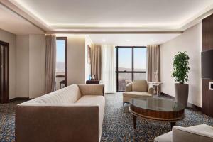 a living room with a couch and a table at Ramada Hotel & Suites by Wyndham Yerevan in Yerevan