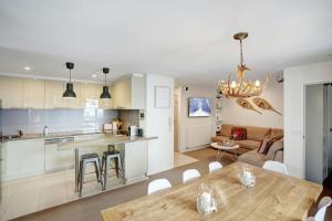 eine Küche und ein Wohnzimmer mit Tisch und ein Esszimmer in der Unterkunft Twin Towers 504B in Mount Buller