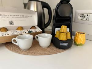 two cups on a counter next to a coffee maker at Praiano Amalfi Coast Casa con Vista Mare in Praiano +25 photos