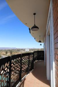 a balcony with a black railing and two lights at Departamento de lujo in Tarija