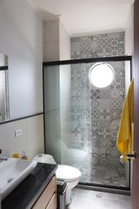 a bathroom with a shower and a toilet and a sink at Departamento de lujo in Tarija
