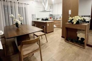 a kitchen with a table and chairs in a room at Departamento de lujo in Tarija