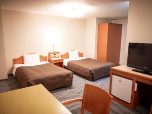 Postel nebo postele na pokoji v ubytování Numazu Grand Hotel + 37 fotografií