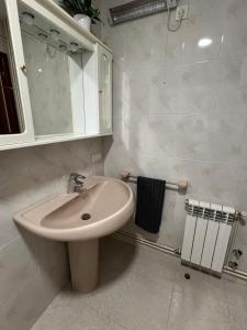 a bathroom with a sink and a mirror at Ático Calvo Sotelo 217 in Sarria