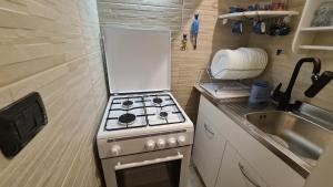 a small kitchen with a stove and a sink at Sea and Blue Sky 3 in Calimera