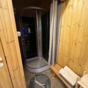 a bathroom with a shower and a bench in a room at Maja saunaga kahele Arturis in Rõmeda