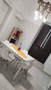 a kitchen with a white table and chairs in a room at Appartamento Bella Vista in Adrano