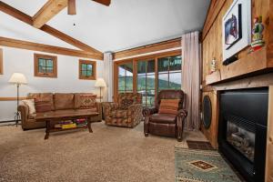 a living room filled with furniture and a fireplace at Hot Tub, Loft with Balcony, Great Views, 2 Bedrooms, 30 Plus Night Rentals Welcome in Steamboat Springs