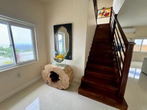 a living room with a staircase and a large mirror at Hospitality Expert BTS 1 - Pool Beach & Chef in Montego Bay +96 photos