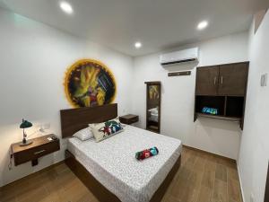 a bedroom with a bed and a painting on the wall at advengers Bucerias Nayarti in Bucerías