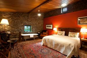 a bedroom with a bed and a bath tub in a room at Olivers Central Otago in Clyde