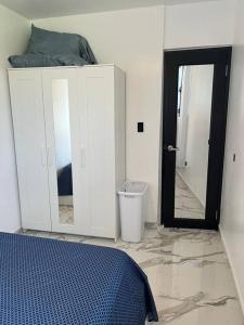 a bedroom with a bed and a mirror and a door at ONE BEDROOM Ocean- Mountain View home five min to beach in Luquillo
