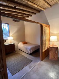 a bedroom with a bed and a mirror at ALDEA DEL MAR by Villa del Sol in Máncora