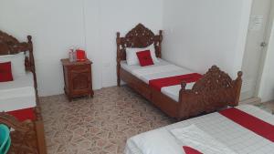 a bedroom with two beds and a night stand at White Castle Beach Resort in Iba