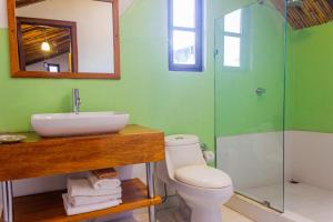 a bathroom with a sink and a toilet and a shower at Hotel Casa de las Rosas in Cuenca