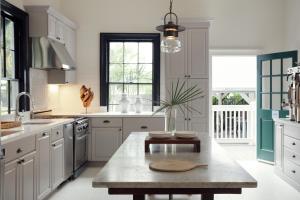 a kitchen with white cabinets and a table at Ridley House - Key West Historic Inns in Key West +16 photos