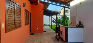 an orange hallway with a bar in a house at Villa Tropicale in Salvador