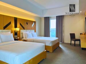 Postel nebo postele na pokoji v ubytování Sotogrande Davao Hotel