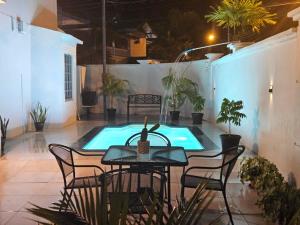 a patio with a table and chairs and a swimming pool at Riverside Bed and Breakfast in San Juan