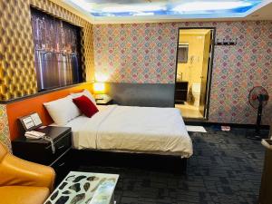 Ένα ή περισσότερα κρεβάτια σε δωμάτιο στο Wecity Hotel 薇城精緻旅店