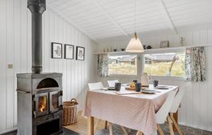 a kitchen with a table and a wood stove at Tziki in Fanø