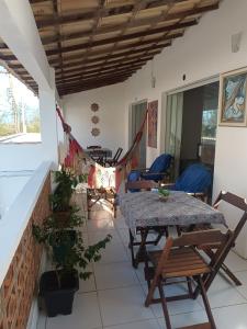 a room with a table and chairs on a patio at Mandalas Guest House in Cabo Frio