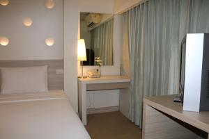 Postel nebo postele na pokoji v ubytování Sunshine Hotel & Residences