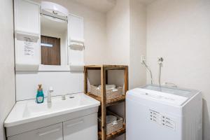 a bathroom with a sink and a washing machine at AI Annex in Osaka +66 photos