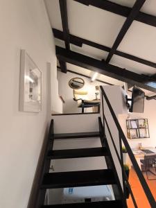 a staircase leading to a room with a desk at Center Vicolo Suite Apartment with Parking in Modena