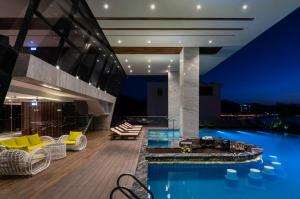 a house with a swimming pool at night at Boton Blue Hotel & Spa in Nha Trang