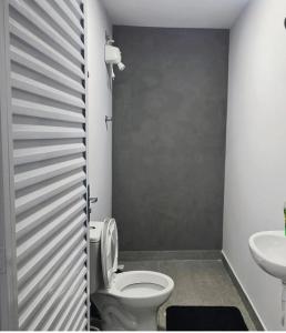 a bathroom with a toilet and a sink at Garden in Viracopos