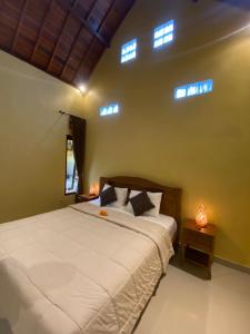 Postel nebo postele na pokoji v ubytování Bali Asli Guest House by EPS