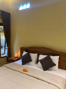 Postel nebo postele na pokoji v ubytování Bali Asli Guest House by EPS