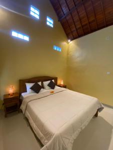Postel nebo postele na pokoji v ubytování Bali Asli Guest House by EPS