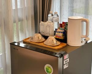 a kitchen with a counter with a toaster and dishes on it at Mont De Pua in Amphoe Pua