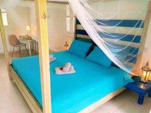 Voodi või voodid majutusasutuse Diamant Vert - Villa Bwa d'Ô, entre mer & montagnes toas