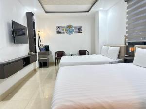 Postel nebo postele na pokoji v ubytování Boss Palace Hotel