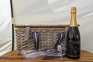 a bottle of wine and a basket on a table at Ingenia Holidays Noosa North in Tewantin