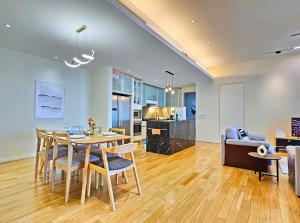 a dining room and living room with a table and chairs at St Mary Kuala Lumpur Homestay Bathtub & Walk to Pavilion Bukit Bintang by Cloud Host in Kuala Lumpur