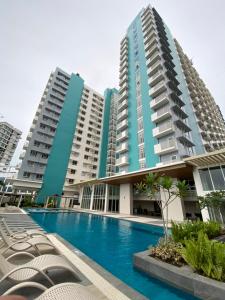 a swimming pool in front of two tall buildings at Isabela 1 Mesavirre Residences in Bacolod