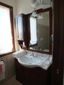 a bathroom with a sink and a mirror at La Cascina della Vachina in Poggio Bustone